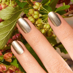 Discover nine vegan nail polish swatches from MANUCURIST INC, including the GREEN™ NAIL POLISH IN METALLIC, along with shades like Mermaid, Nebula, Disco, Moon, Diamant, Quartz, Fairy, Tweed, and Pearlescent. Each features shimmery or pearly finishes in a range of vibrant colors. These non-toxic polishes include striking iridescent gold effects for a glamorous manicure.