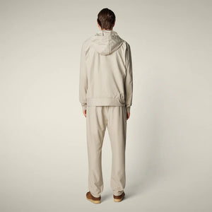 SAVE THE DUCK - MICHAEL MEN'S TECH TROUSERS: Beige straight-leg men’s pants from SAVE THE DUCK, featuring an elastic waistband and crease-resistant stretch fabric, shown on a plain light background.