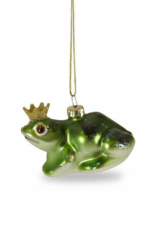 The CODY FOSTER HERALDLY FROG ORNAMENT features a shiny green finish, glittery gold crown, and gold hanging string—a whimsical decor piece perfect for collectors or as a unique gift for design lovers.