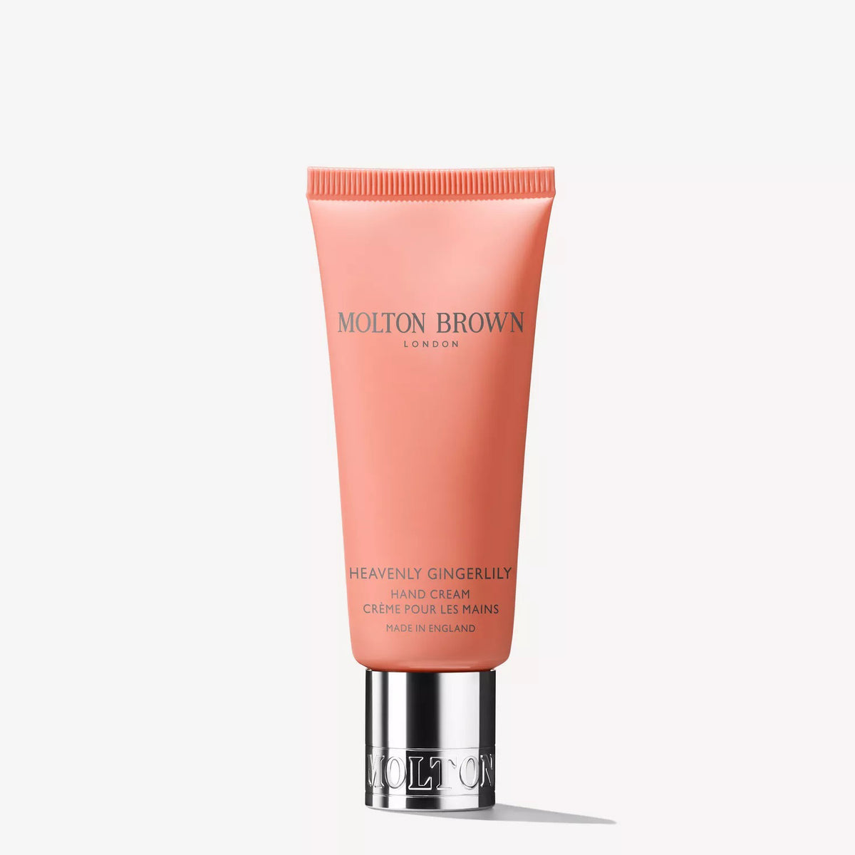 The MOLTON BROWN - HEAVENLY GINGERLILY HAND CREAM comes in a pink tube with a silver cap and provides hydrating care with every use.