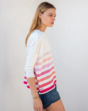 Woman wearing the MERSEA - CATALINA CREWNECK SWEATER, white with two black stripes, paired with denim shorts and a gold necklace—an essential piece from MERSEA for effortless, versatile style.