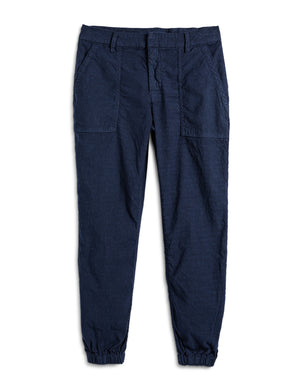 Introducing the FRANK & EILEEN JAMESON UTILITY JOGGER IN PERFORMANCE LINEN NAVY: a pair of high-rise jogger cargo pants crafted from textured Italian Performance Linen in a deep navy hue. These stylish joggers feature two front utility pockets, two large side pockets, an elastic waistband with belt loops, and elastic cuffs at the ankles. The pants are displayed on a plain white background.