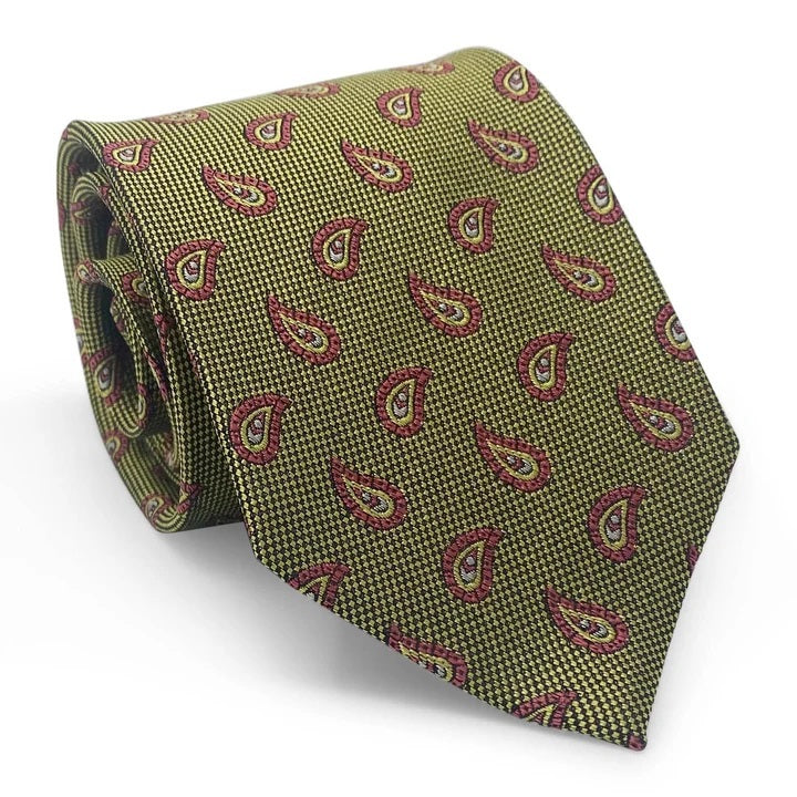A close-up of the PETER-BLAIR - ALBEMARLE SILK TIE IN YELLOW by BIRD DOG BAY showcases a yellow and black houndstooth pattern, accented with evenly spaced red and pink paisley designs. Handmade in New York, this woven silk tie features an elegantly pointed tip.