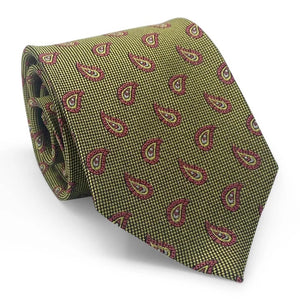 A close-up of the PETER-BLAIR - ALBEMARLE SILK TIE IN YELLOW by BIRD DOG BAY showcases a yellow and black houndstooth pattern, accented with evenly spaced red and pink paisley designs. Handmade in New York, this woven silk tie features an elegantly pointed tip.