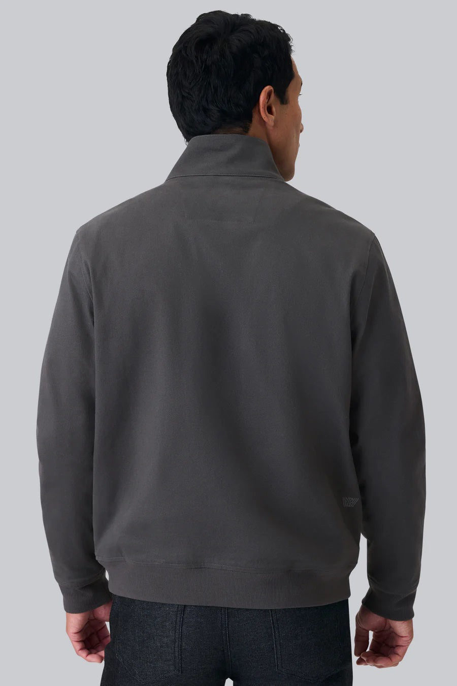 The MACK WELDON Twill Harrington Jacket in Asphalt is a dark gray cotton cavalry twill zip-up with a stand collar, two angled button-flap pockets, ribbed cuffs and hem, offering an English jacket style. Shown on a black background.