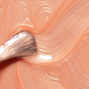 A bottle of MANUCURIST INC GREEN™ Nail Polish in Grapefruit, featuring a peachy-pink color and a black cap.