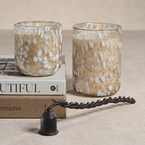 SPECKLED LUMINA TONKA ABSOLUTE SCENTED CANDLE 21.5OZ cylindrical glass candle holder featuring a brown and white speckled pattern.