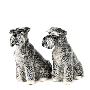 The QUAIL DESIGNS QUAIL CERAMICS Schnauzer Salt and Pepper Set features two handpainted stoneware figurines with gray, black, and white details, capturing the bearded faces and textured fur of schnauzers against a white background.