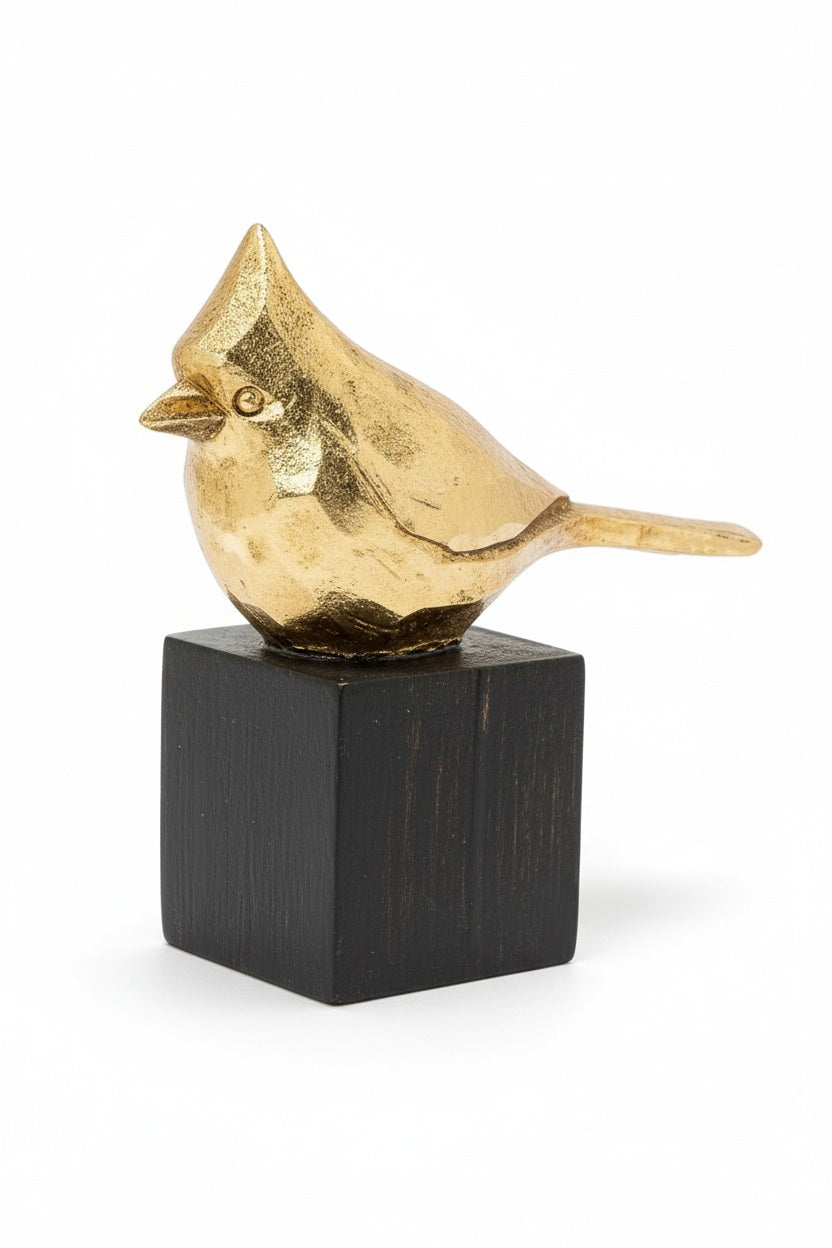 A golden SMALL CARDINAL CURIO figurine perched on a black square base, perfect for a display shelf.