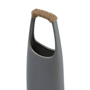 The CREATIVE COOP STONEWARE VASE WITH RATTAN WRAPPED HANDLE, GREY, stands tall with a matte finish and elongated oval opening, making a striking decorative centerpiece against a white background.