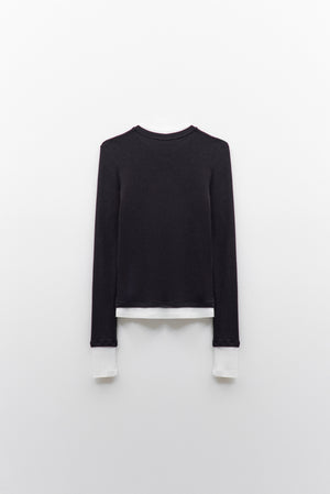 The ELEH - THE CONTRAST LAYER TOP by ELEH is a modern black long-sleeved sweater with white trim on the collar, cuffs, and hem—an effortlessly versatile wardrobe essential shown flat against a white background.