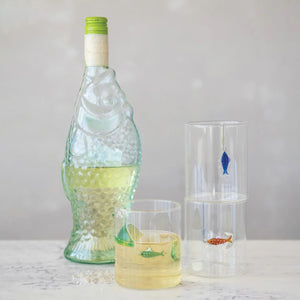 Set of three CREATIVE COOP HAND-BLOWN DRINKING GLASS WITH FISH ON HOOK, each with a unique green, blue, or red fish design—perfect for adding a playful accent to any coastal décor.