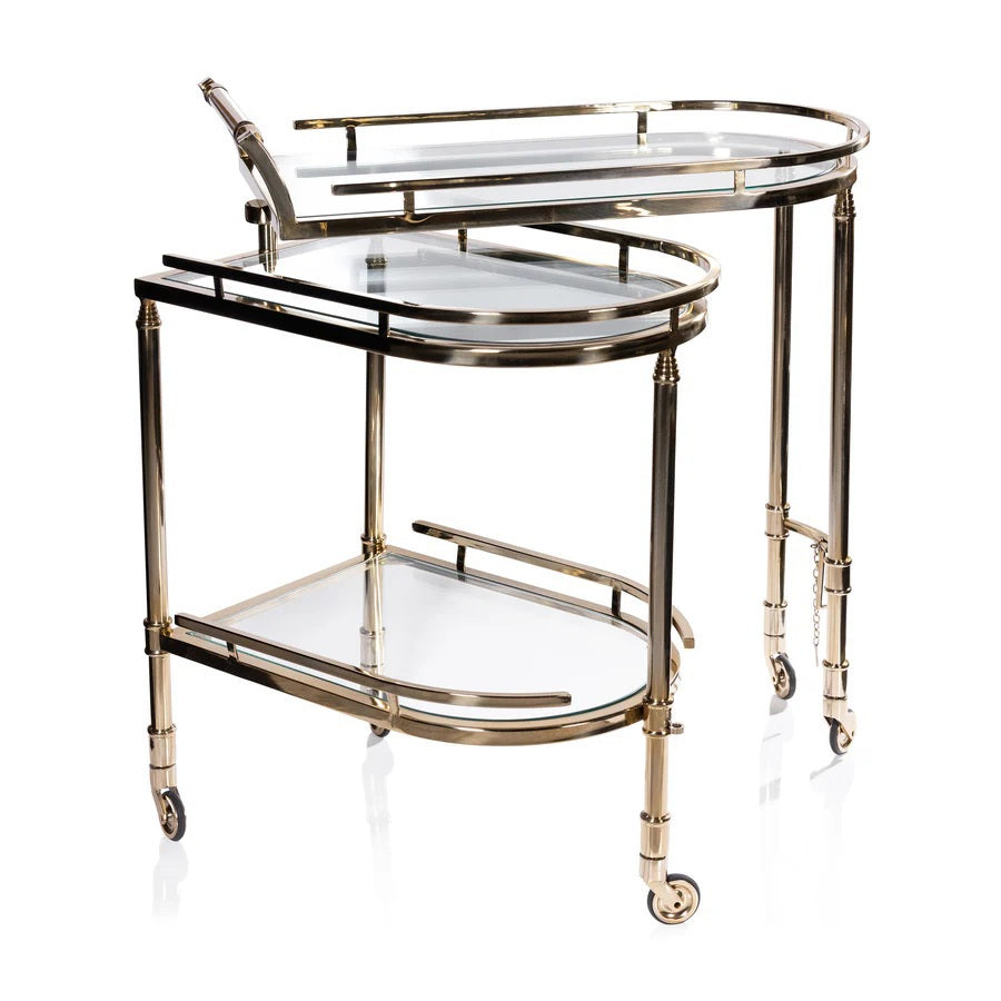 The SPIGA GOLD BAR CART by ZODAX features a vintage Italian-inspired design with elegant gold framing, mirrored glass shelves on both tiers, and smooth-rolling four-wheel mobility. Displayed against a white background, this piece is both stylish and functional.