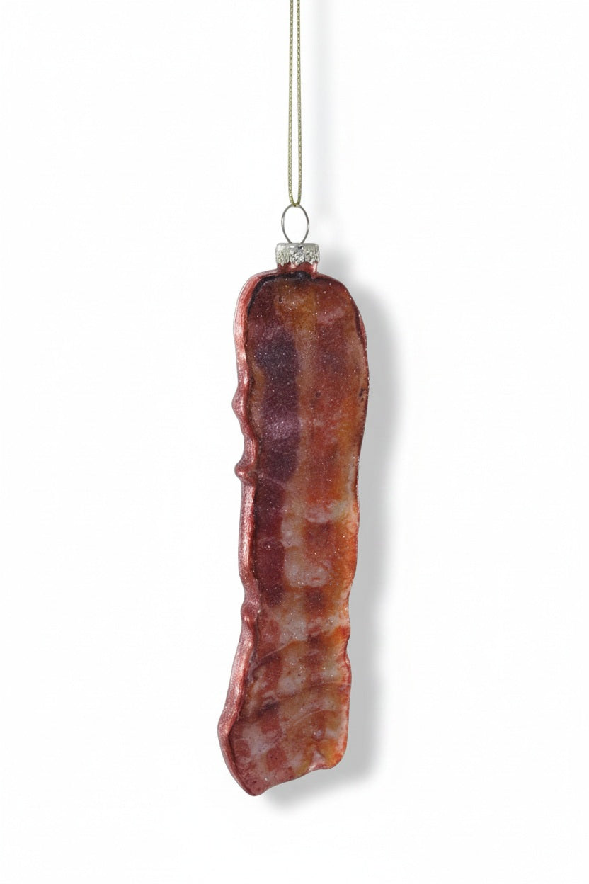 A CRISPY BACON ORNAMENT shaped like a slice of cooked bacon, designed as a hanging glass accessory.