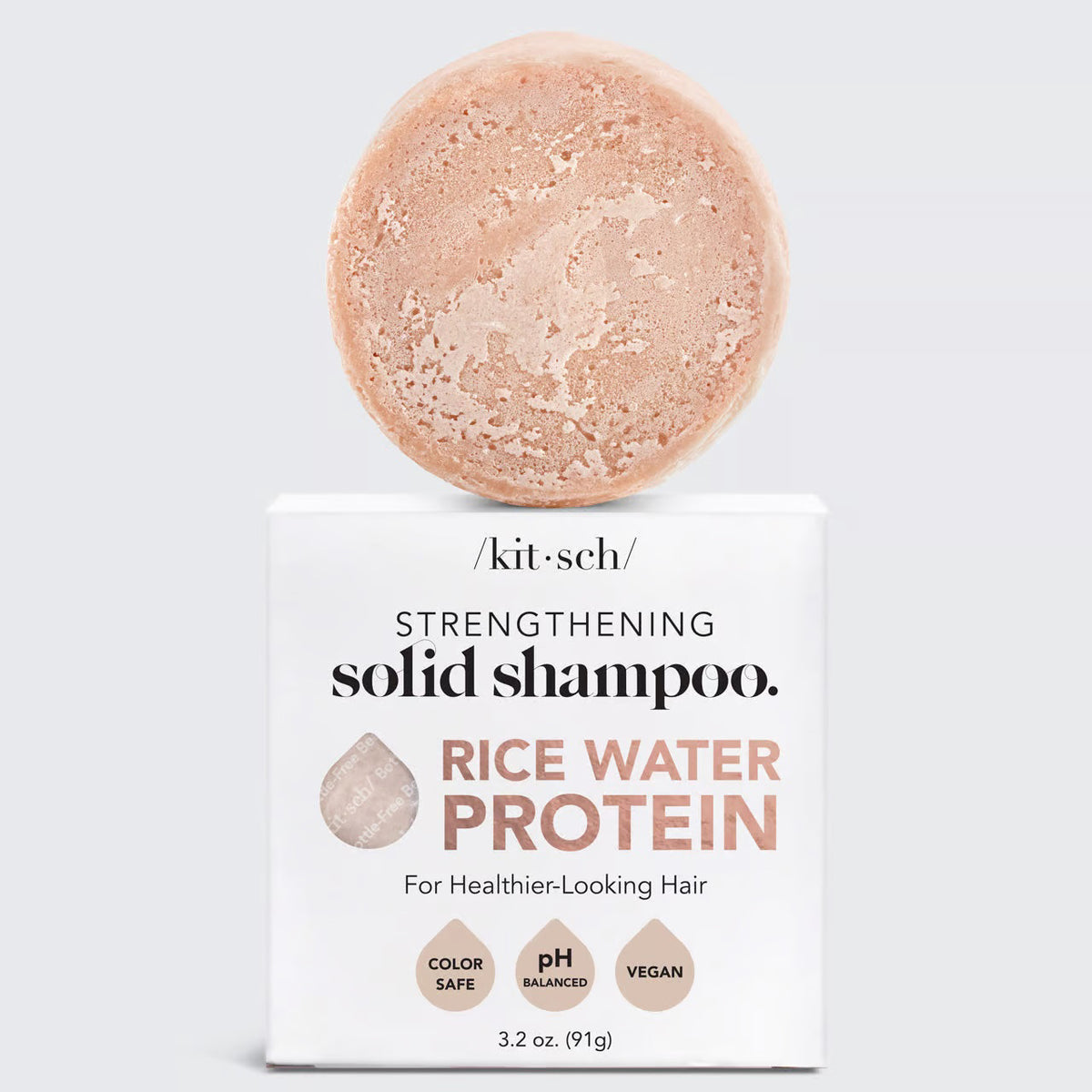 Image of a KITSCH Rice Water Protein Solid Shampoo Bar, featuring a marbled light brown shade. Packaged on a white box labeled for hair growth, it's color-safe, pH balanced, and vegan. Net weight: 3.2 oz (91g).