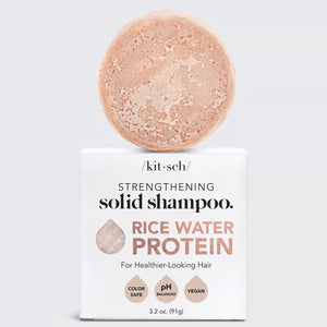 Image of a KITSCH Rice Water Protein Solid Shampoo Bar, featuring a marbled light brown shade. Packaged on a white box labeled for hair growth, it's color-safe, pH balanced, and vegan. Net weight: 3.2 oz (91g).