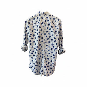 A man with short gray hair and a beard wears the FRANK & EILEEN Finbar Men's Button Up Shirt in Blue and White Small Flowers Big Flowers. He pairs it with dark jeans, standing against a plain white background for an everyday look.
