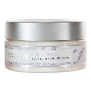 A 200 ml (6.7 fl oz) jar of BODY BUTTER - LAVENDER by EUROPEAN SOAPS, LLC, enriched with shea butter for deep moisturization. The round container features a silver lid and a white label adorned with light lavender illustrations and details about the product in both English and French.
