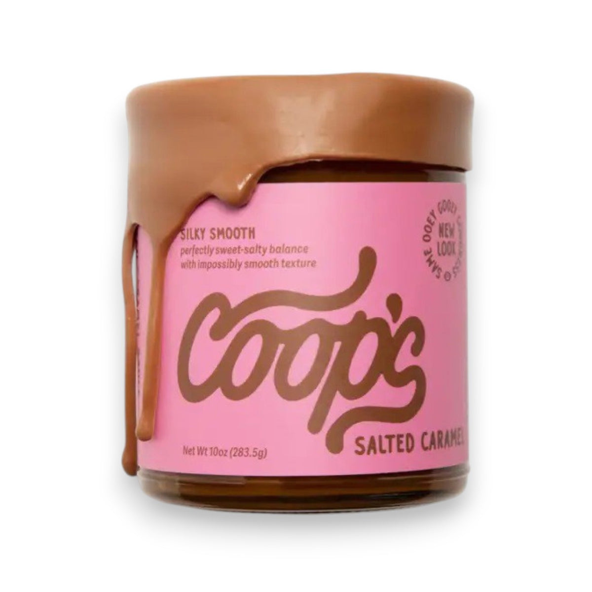 A jar of COOPS - SALTED CARAMEL SAUCE with pink labeling sits open, its thick, silky smooth sauce dripping down the side. The label reads "COOPS," boasting an all-natural, gluten-free treat with a perfectly sweet-salty balance and impossibly smooth texture.