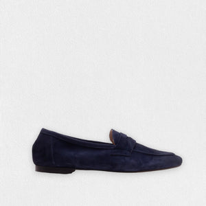 A side view showcases the MICHELE LOPRIORE - PAOLA SUEDE LOAFER in beige against a white background. This mocassin-style loafer, crafted from genuine leather, features a smooth texture with a simple design and low heel.