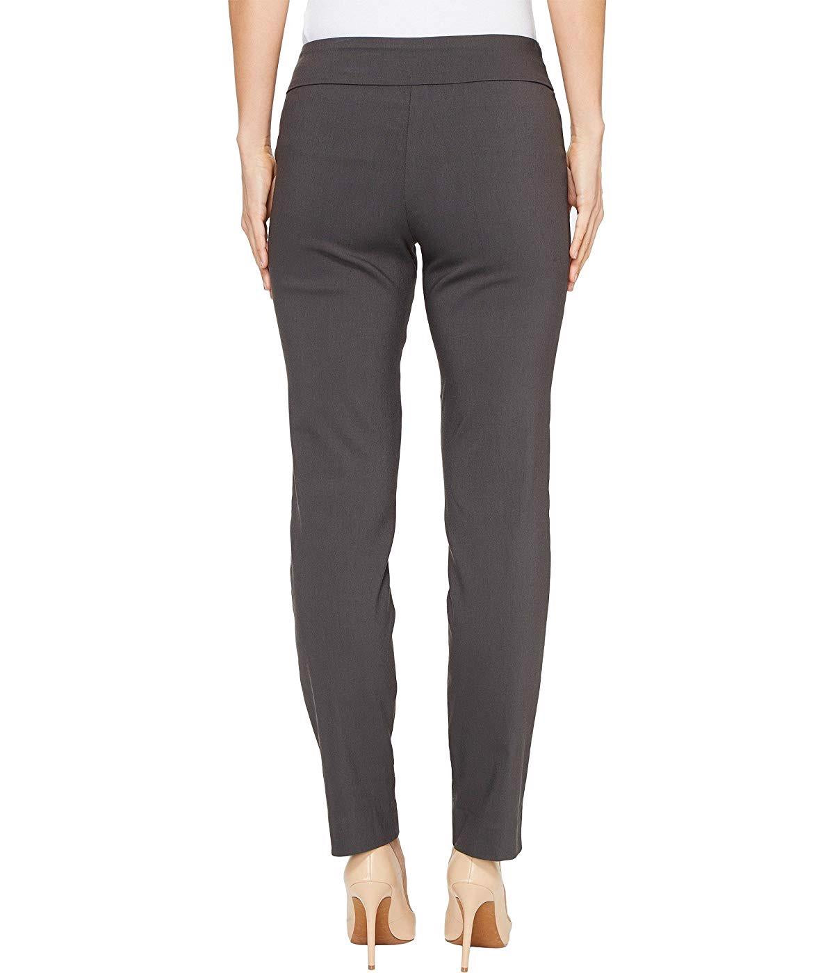 A person is wearing KRAZY LARRY, INC&#39;s PULL ON ANKLE PANT in a slim fit beige straight-leg style and black high-heeled shoes against a white background. The outfit is completed with a sleeveless black top that reveals part of the arms and torso.