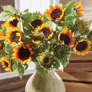 The NAPA HOME AND GARDEN - SUNFLOWER STEM features two vibrant, natural-looking sunflowers with dark brown centers and bright yellow petals on long stems, complete with lush green leaves and tied with twine, perfect for adding a touch of Napa's charm to your home decor.