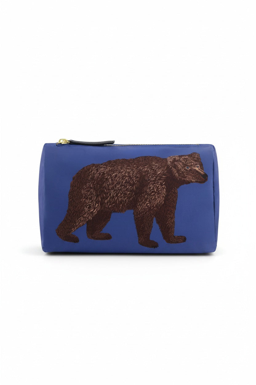 The INOUI EDITIONS - BEAR COSMETIC POUCH by INOUI is a blue zippered pouch made in India, featuring a detailed illustration of a brown bear walking, shown against a plain white background.