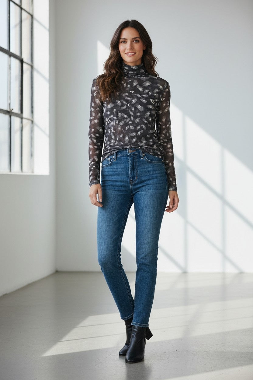 The FRANCO FERRARI - BALLET MESH TURTLENECK is a fitted, sheer mesh top with an abstract monochrome print of scattered light brushstroke spots, shown against a white background.