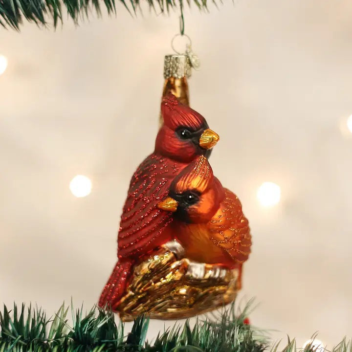 OLD WORLD CHRISTMAS PAIR OF CARDINALS ORNAMENT, a glass design featuring a pair of cardinals perched together in a nest.