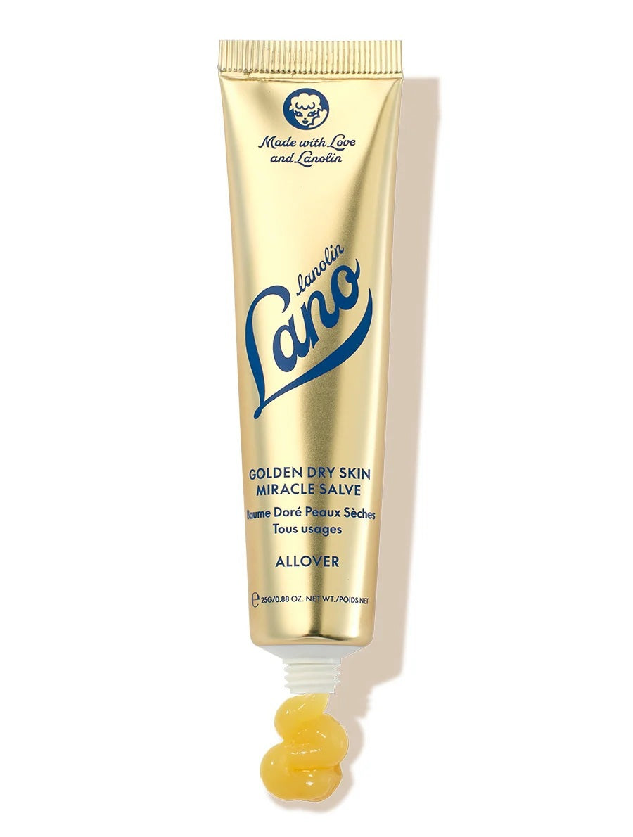 A gold tube of LANOLIPS - GOLDEN DRY SKIN MIRACLE SALVE from LANOLIPS, featuring blue text and a white cap. The label states “Made with Love and Lanolin” and describes it as an intensive hydration ointment for all-over use on dry skin.