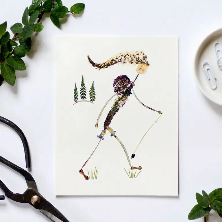 The PETAL PEOPLE PRESS - HIKE CARD by PETAL PEOPLE PRESS features a walking figure crafted from dried flowers and leaves—a unique botanical card perfect for nature lovers.