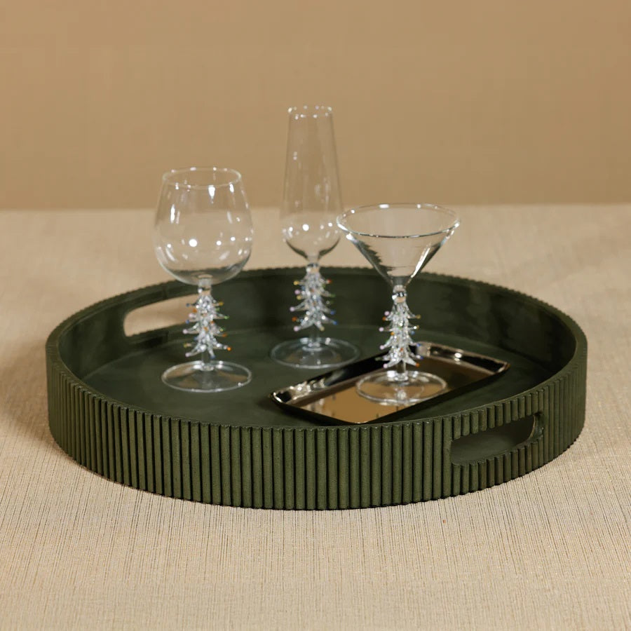 Close-up of the ZODAX ROUND FLUTED LEATHER TRAY IN GREEN, showcasing a smooth top and vertical, evenly spaced ridges on the sides for a modern, textured look.