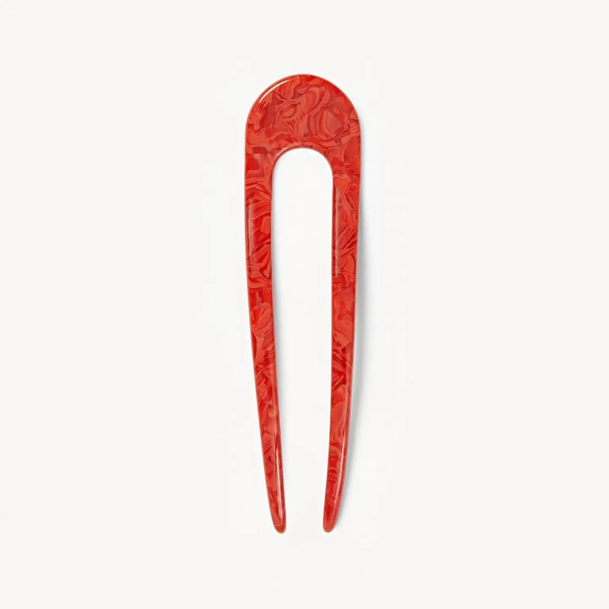 The MACHETE - FRENCH HAIR PIN IN POPPY is a handcrafted, red marbled two-pronged French hair pin with a rounded top, made from Italian acetate by MACHETE, shown on a plain white background.