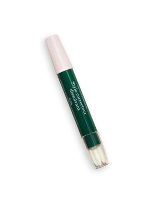 The MANICURIST - CORRECTOR PEN by MANUCURIST INC is a green and pink pen with a clear cap and white brush tip labeled “Stylo correcteur,” ideal for fixing nail polish or gel errors. Shown lying on a white background.
