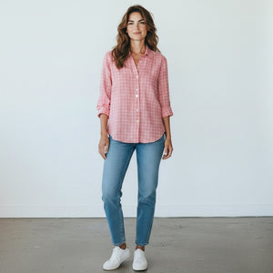 The FRANK & EILEEN - EILEEN Relaxed Button Up in Italian Linen Red and White Grid features a long-sleeve, collared design with slightly rolled sleeves and a relaxed fit. Expertly crafted from luxurious Italian linen, this shirt showcases bust-flattering button placement and a striking red and white grid pattern. The shirt is labeled “Frank & Eileen EST 1947.”.