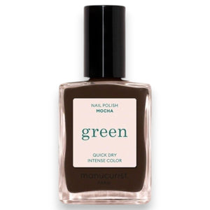 A hand with short nails painted in MANUCURIST - GREEN™ Nail Polish in Mocha by MANUCURIST INC rests on a shiny, metallic, wavy-edged object against a deep red background.