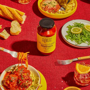 A jar of SAUZ Summer Lemon Marinara, featuring a vibrant yellow label with “Zesty Citrus Tomato Sauce,” showcases bold, savory flavors made from locally-sourced ingredients.