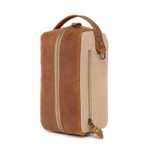 The TSD BRAND - VALLEY OAK TOILETRY BAG IN KHAKI is a handcrafted toiletry bag with a handle, shown open from above to reveal its empty beige fabric-lined interior—perfect for organized travel.