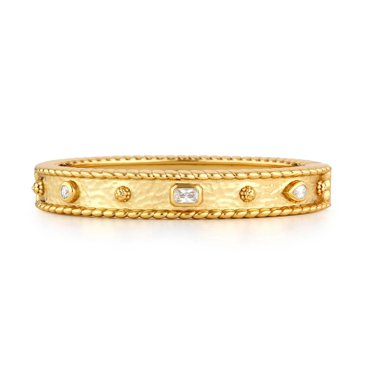 The CAPUCINE DE WULF BERRY GEM BRACELET is a beautifully handcrafted piece featuring an 18K gold-plated band with a hammered texture, rope-like edges, and sparkling diamonds in round, oval, and teardrop shapes evenly spaced around the bracelet—a stunning design inspired by the luxurious elegance of a cabochon gemstone accessory.