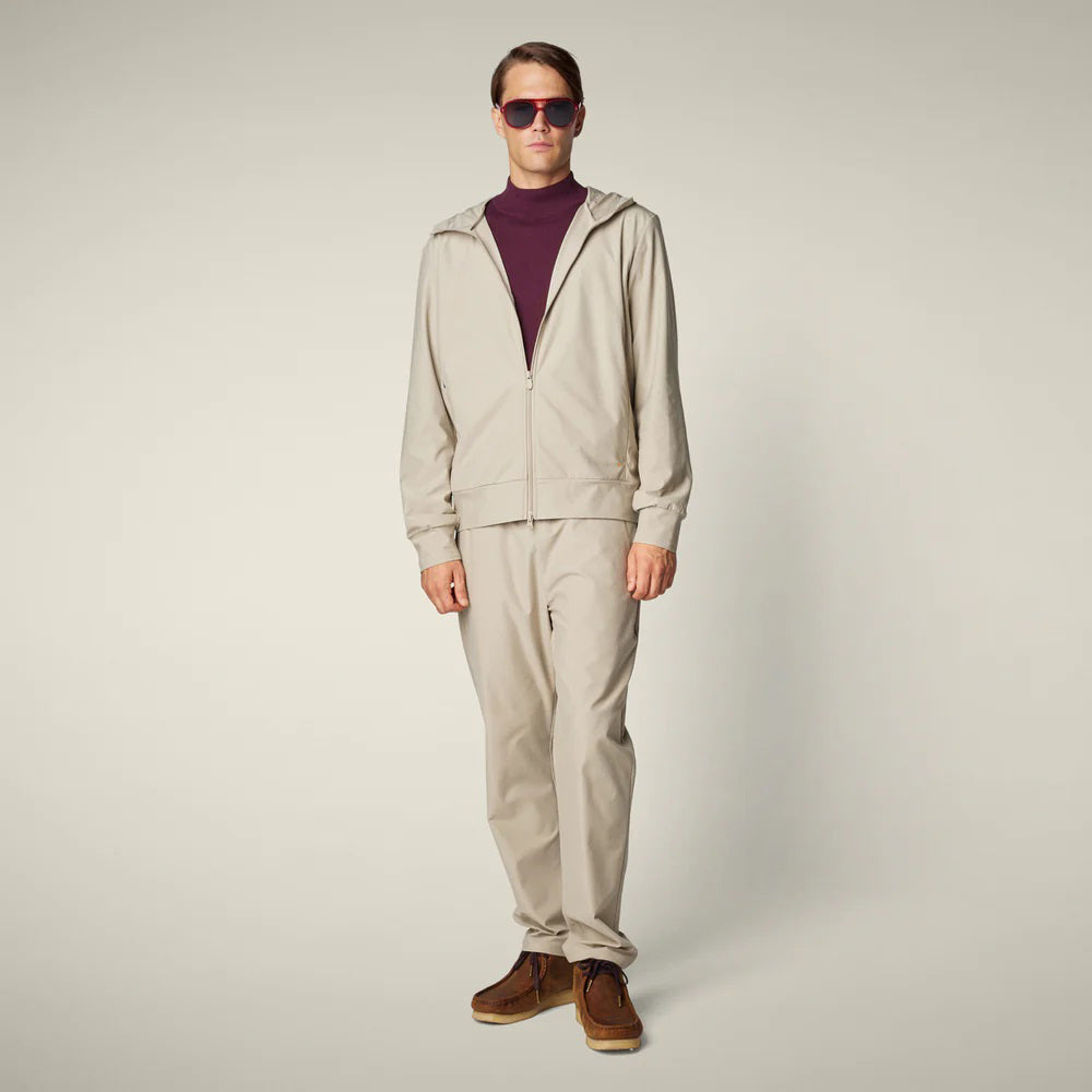 SAVE THE DUCK - MICHAEL MEN'S TECH TROUSERS: Beige straight-leg men’s pants from SAVE THE DUCK, featuring an elastic waistband and crease-resistant stretch fabric, shown on a plain light background.