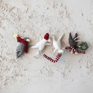 The CREATIVE COOP FELT MICE HANGING FROM WREATH features four playful felt mice dressed in winter hats and scarves, each hanging vertically, with one mouse holding a tiny wreath and another holding a star.