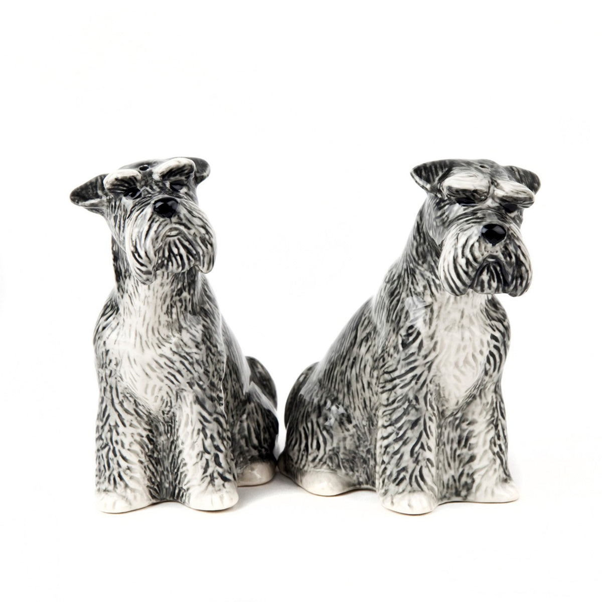 The QUAIL DESIGNS QUAIL CERAMICS Schnauzer Salt and Pepper Set features two handpainted stoneware figurines with gray, black, and white details, capturing the bearded faces and textured fur of schnauzers against a white background.