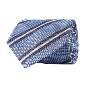 Introducing the AMANDA CHRISTENSEN - Striped Jacquard Woven Silk Tie in Sky Blue Melange: a refined addition to your men’s accessories collection, featuring a rolled-up jacquard woven silk design with an elegant textured pattern and diagonal white and dark blue stripes.