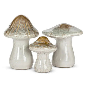 Three LARGE CERAMIC MUSHROOM décor pieces in varying sizes and shades of white, brown, and green, styled as a woodland-inspired set.