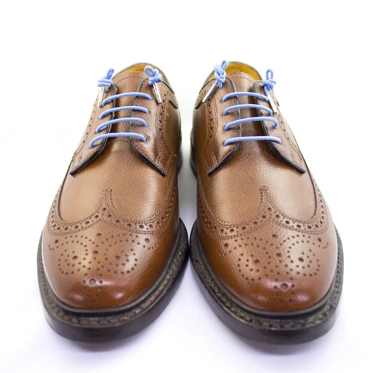 A pair of STOLEN RICHES dress shoes featuring decorative perforations and Bishop Blue STOLEN RICHES shoelaces, displayed side by side on a white background.