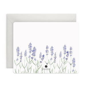 A box of E. FRANCES PAPER's LAVENDER FLAT NOTES, ideal for sharing thoughtful words. The front card displays a delicate watercolor of lavender flowers, while the pastel green packaging features a minimalist design, making it a perfect small gift.