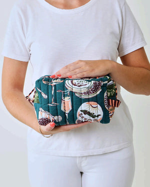 Adorned with an illustrated pattern of caviar tins, open shells brimming with caviar, delicate spoons, and tall champagne glasses on a rich peacock feather green background, the PRINTFRESH - CHAMPAGNE & CAVIAR QUILTED POUCH IN PEACOCK FEATHER is an elegant accessory from PRINTFRESH. This stylish pouch makes a perfect gift for her.