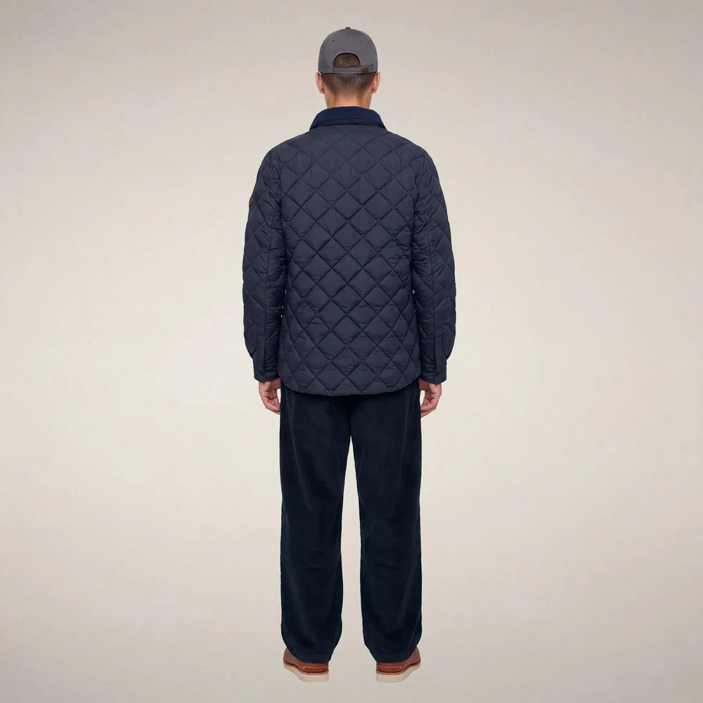 The SAVE THE DUCK - FIRMIN Puffer Jacket in Blue Black by SAVE THE DUCK features a diamond-quilted design, long sleeves, snap button closures, two chest pockets with flaps, and a dark collar, presented against a plain light background.