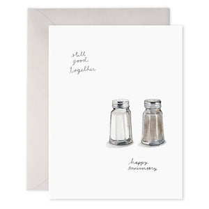 The E. FRANCES - SALT N PEPA ANNIVERSARY CARD by E. FRANCES PAPER features watercolor salt and pepper shakers with "still good together" and "happy anniversary" on heavyweight paper, visible envelope included, made in the USA.