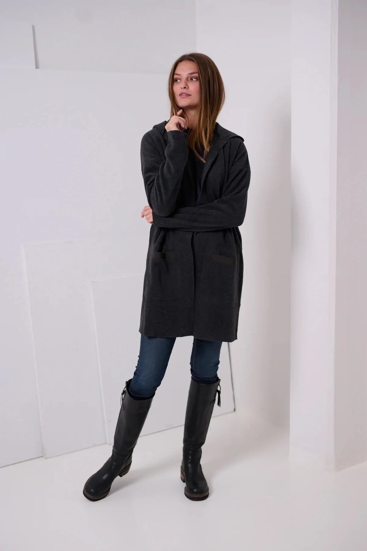 The HENRIETTA STEFFENSEN - FLEECE HOODED CARDIGAN by HENRIETTE STEFFENSED is a black, knee-length, open-front coat with long sleeves and no visible buttons or zippers, crafted from recycled polyester and shown on a plain white background.